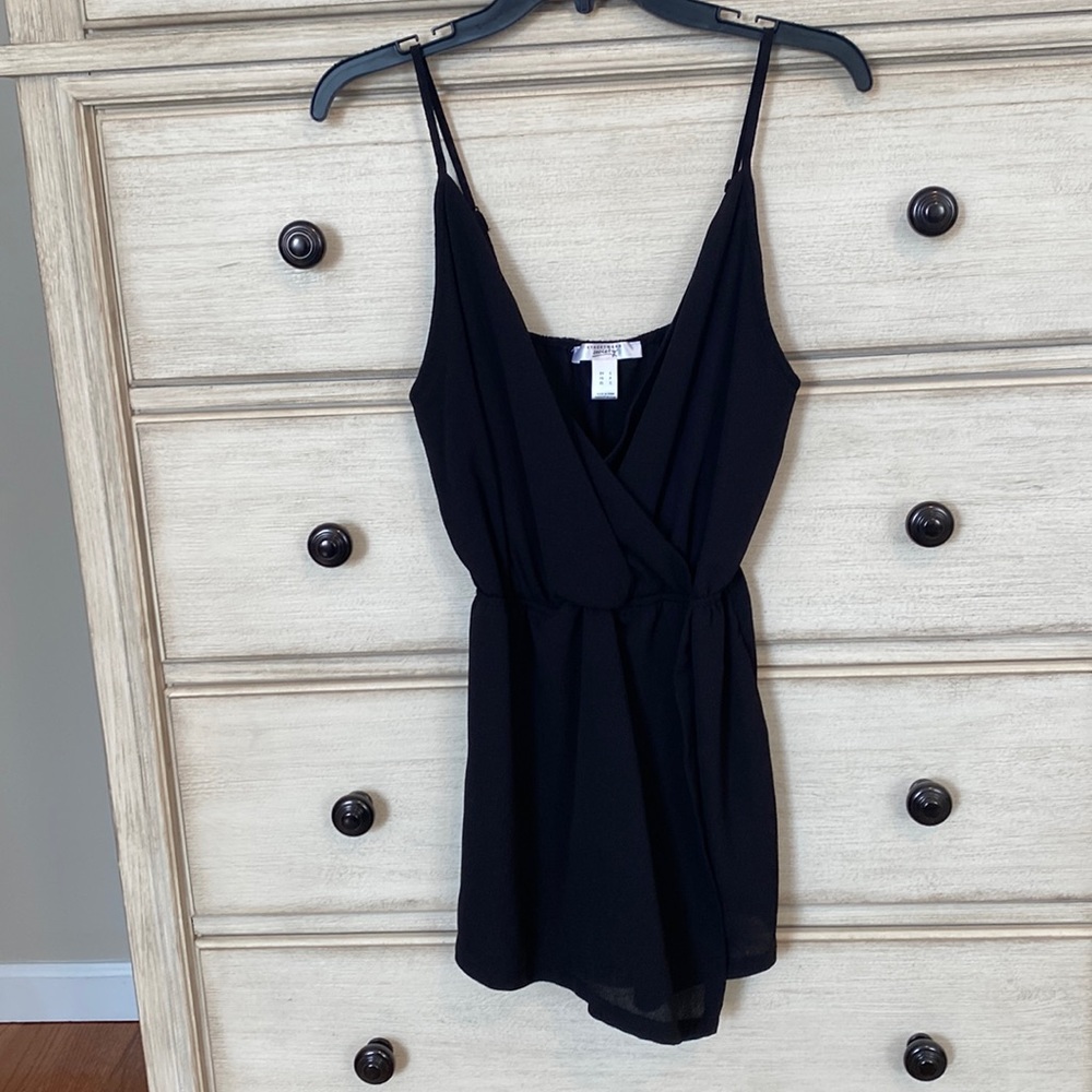 Black romper with cross front v-neck